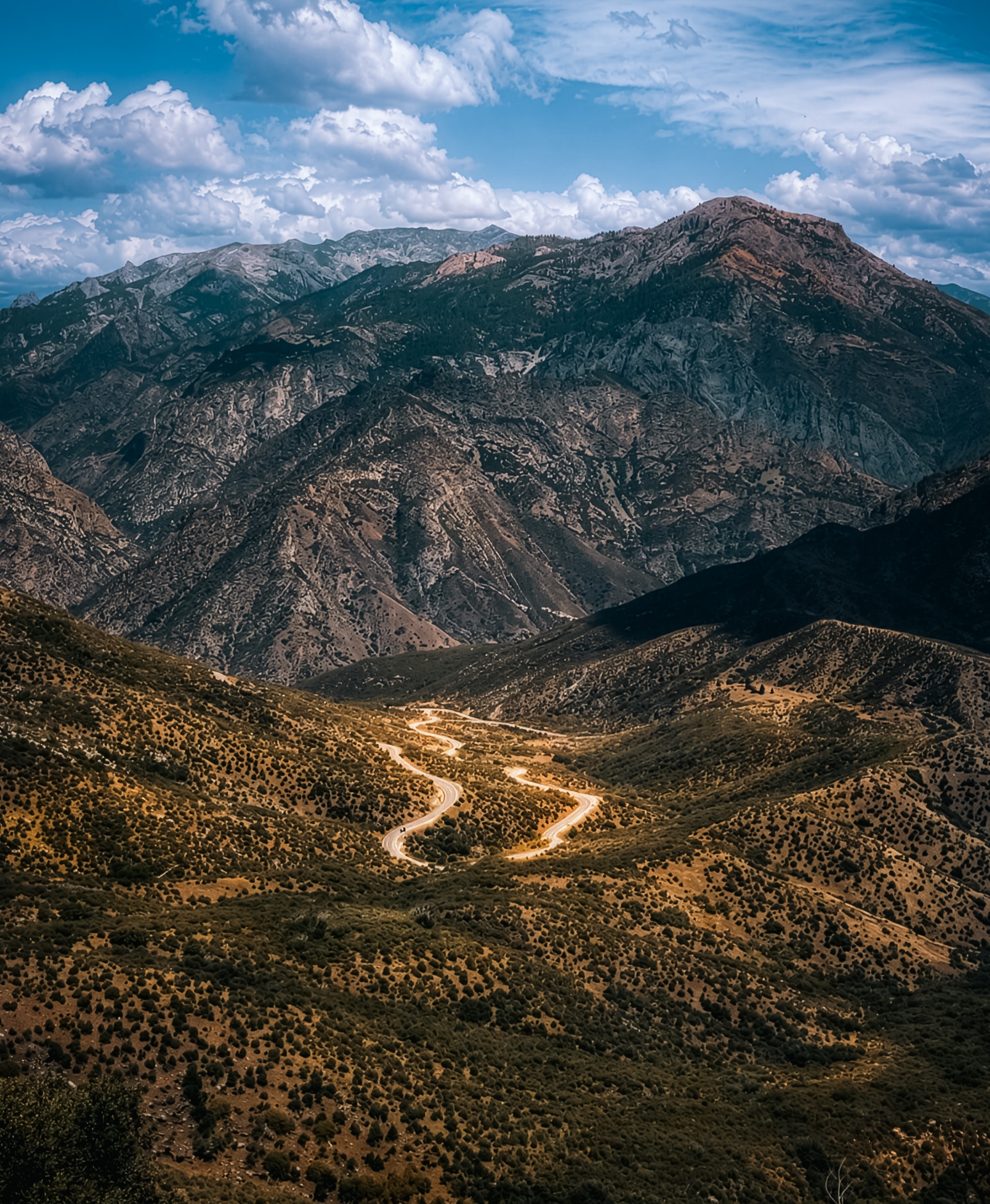Winding mountain road through alpine valley