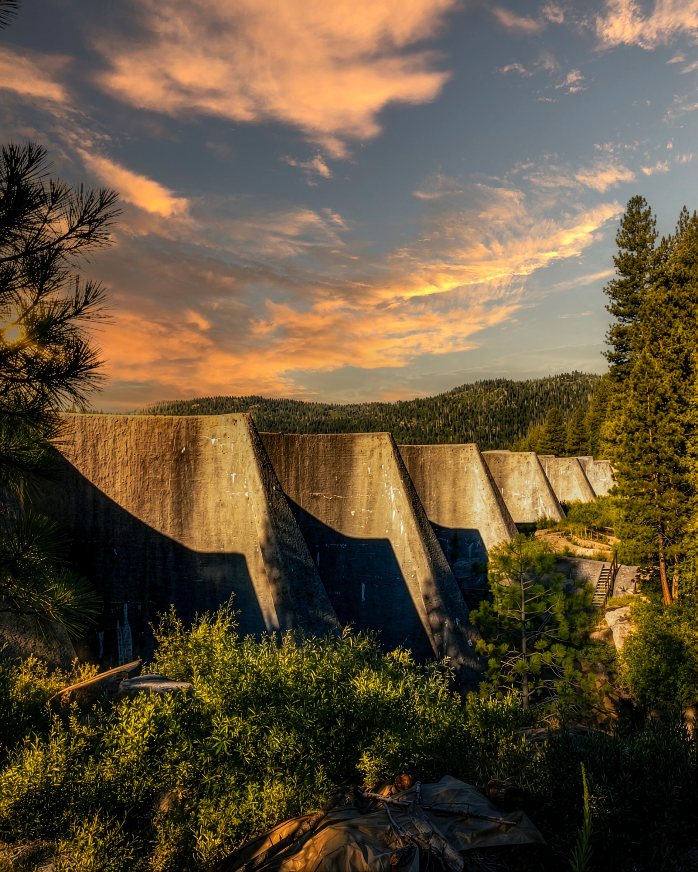 Dam spillway forest mountains sunset