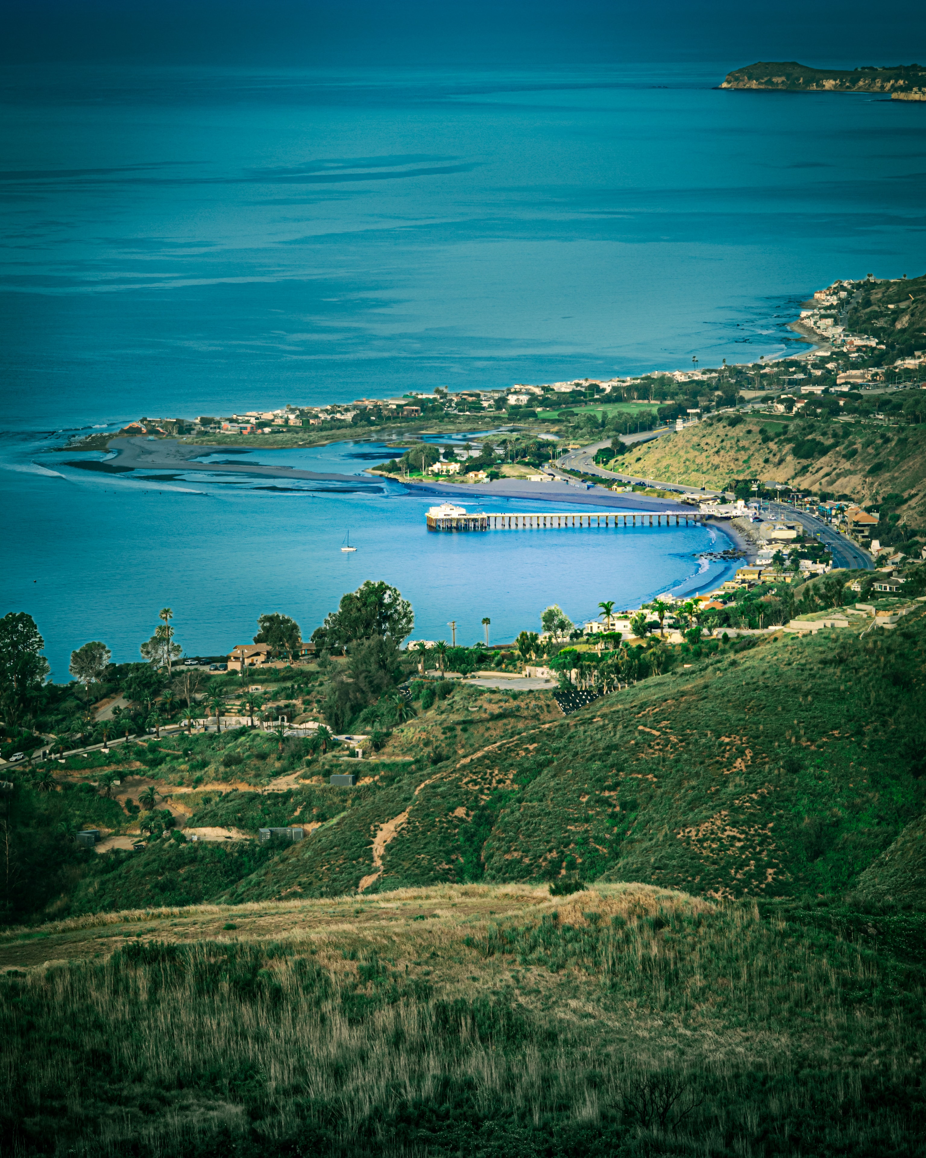 Aerial view of coastal bay and pier