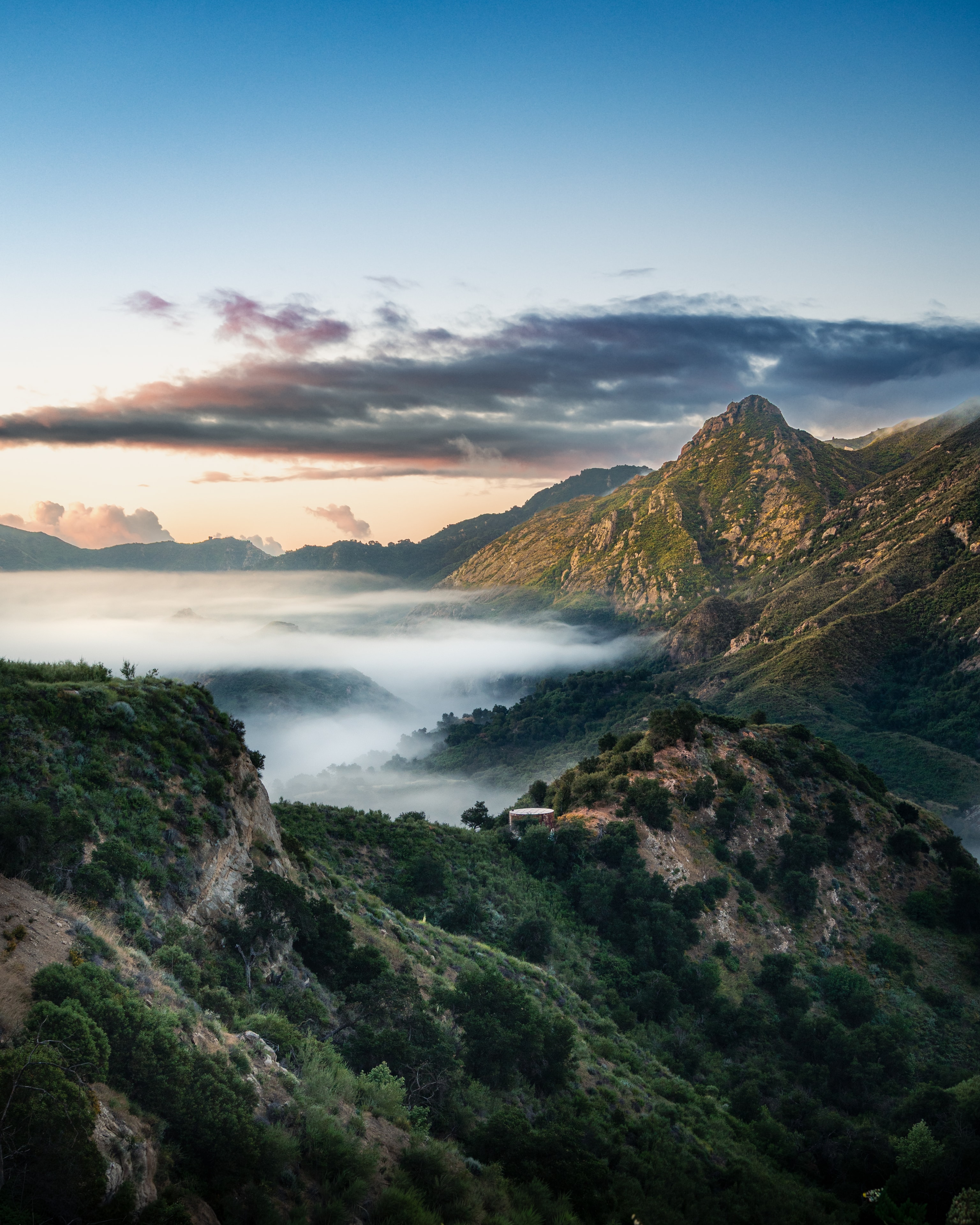 Fog rolling through mountain canyon at dawn