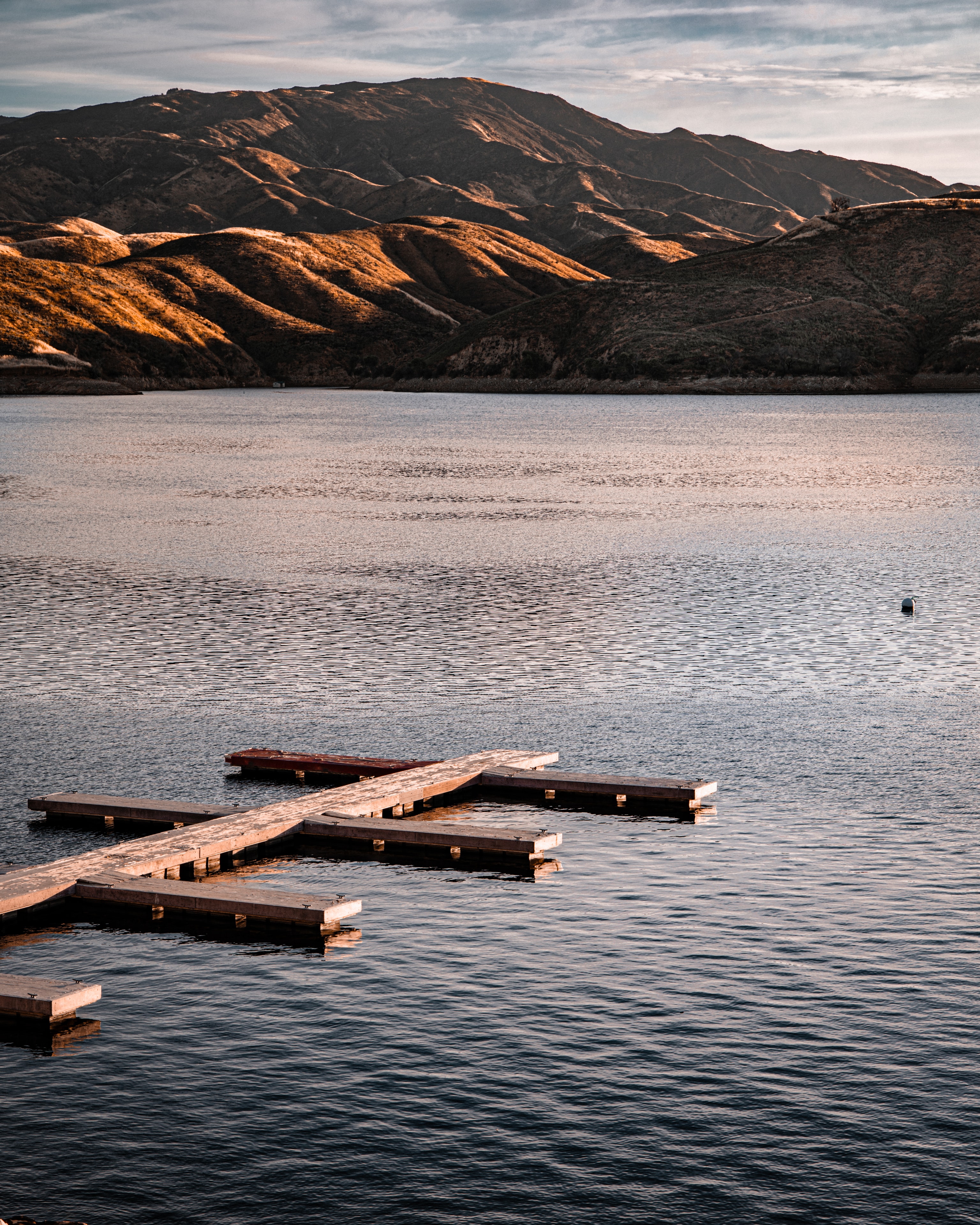 Wooden dock floating on still mountain lake