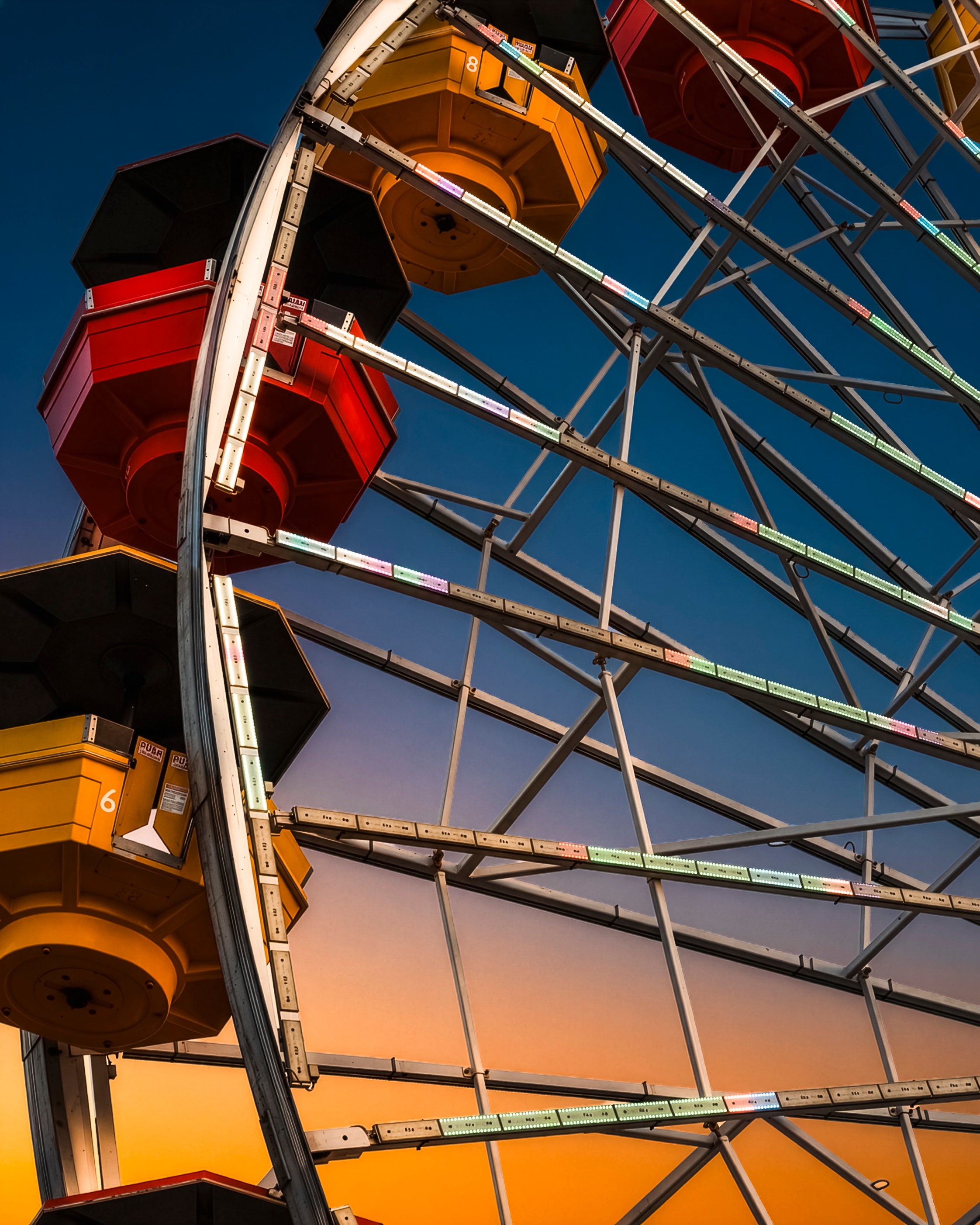 Colorful Ferris wheel close-up at twilight