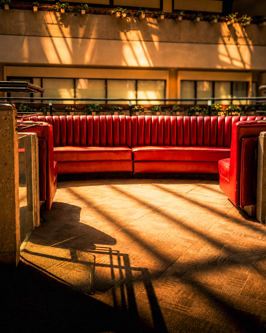 Red leather booth seating with dramatic light and shadows