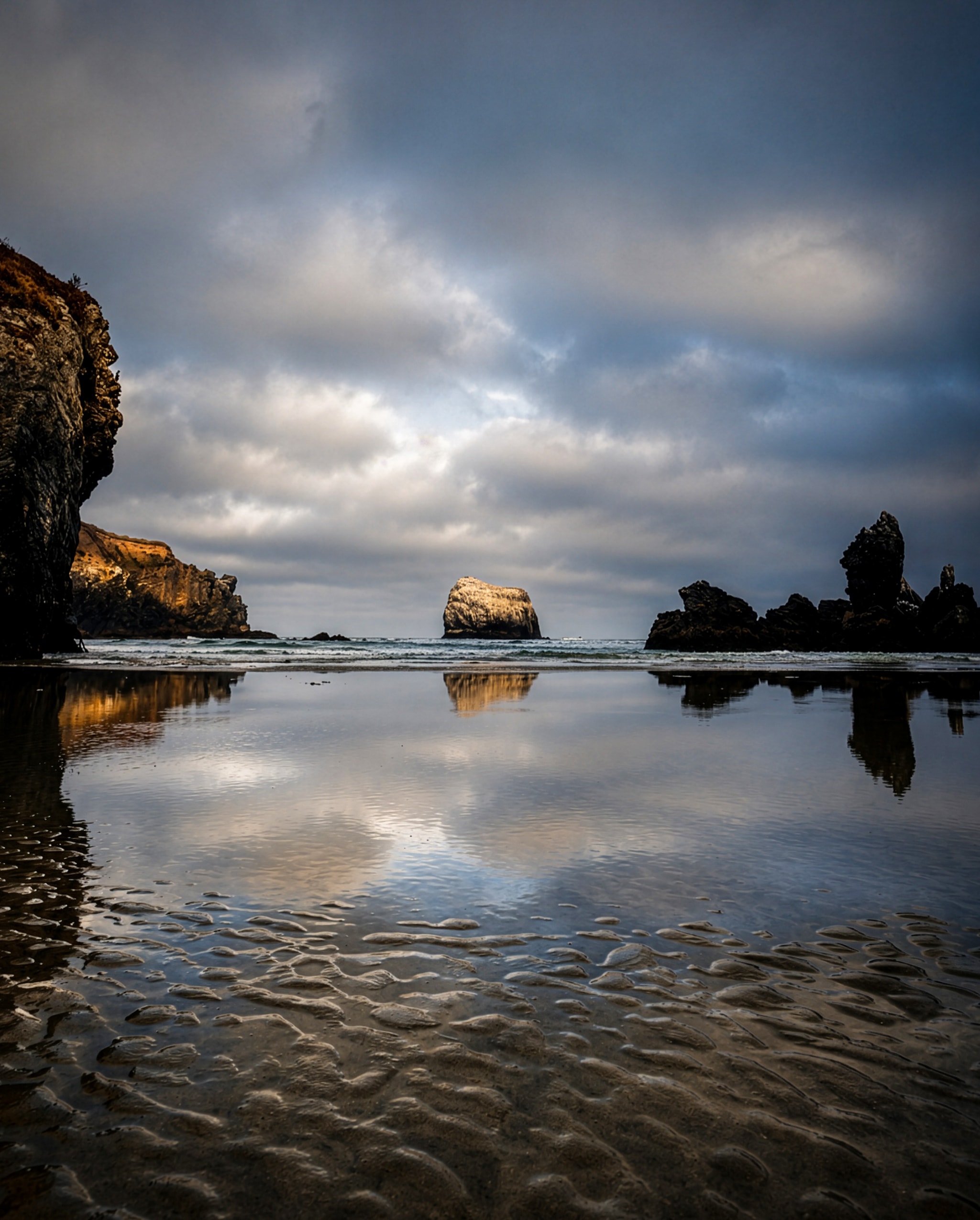 Sea stacks reflected in tidal pools at low tide