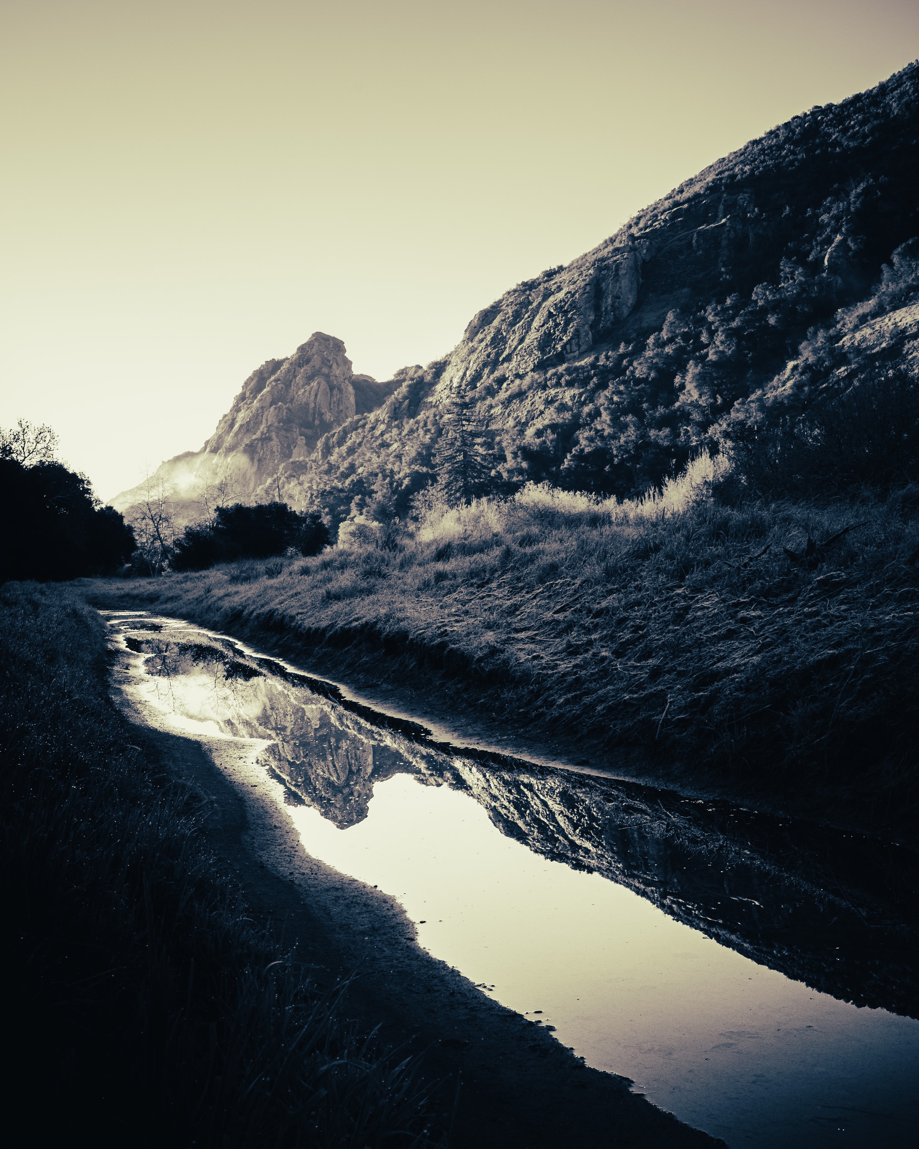 Mountain valley with reflective stream